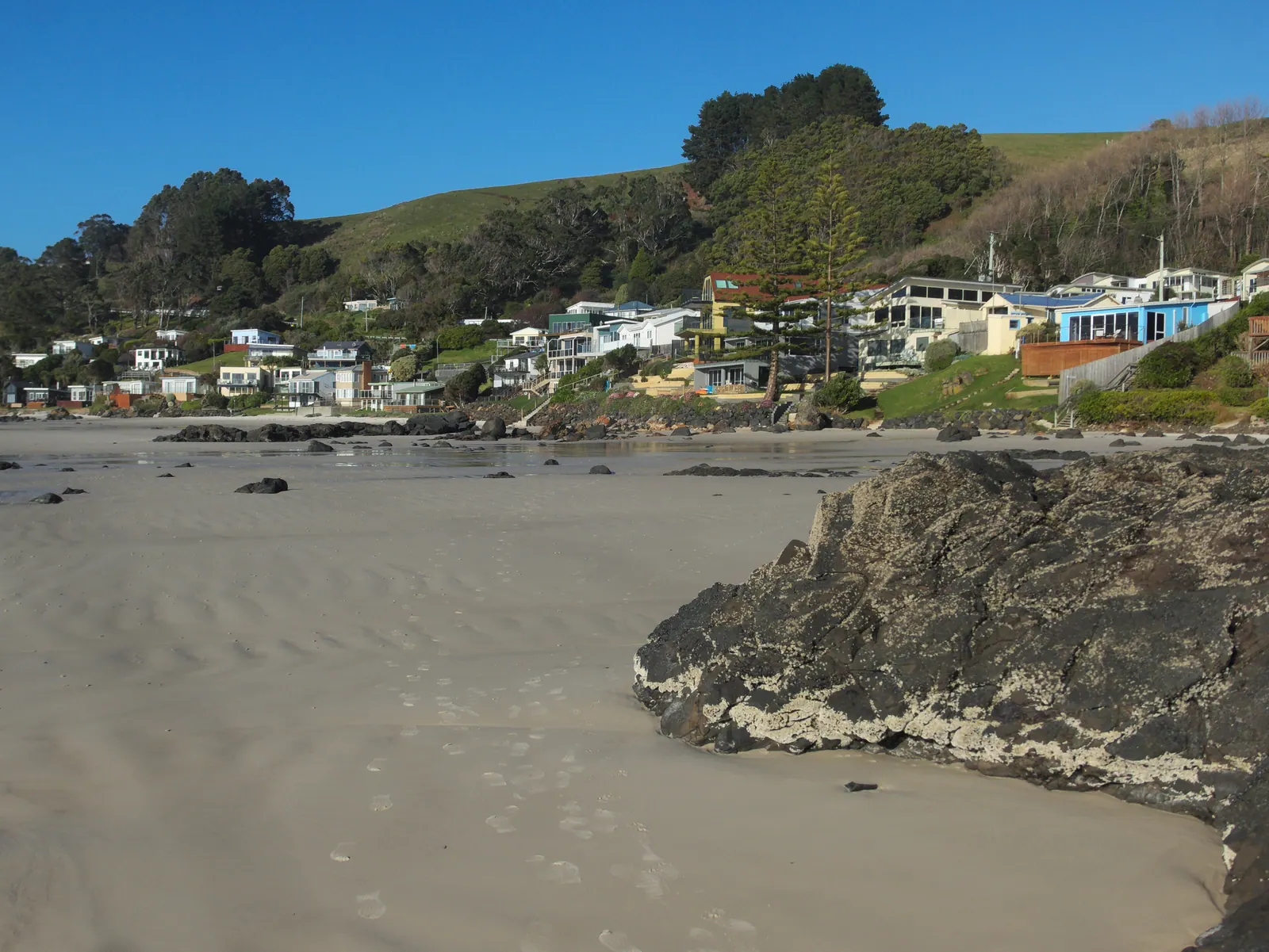 A sandy beach and calm sea on a bright day