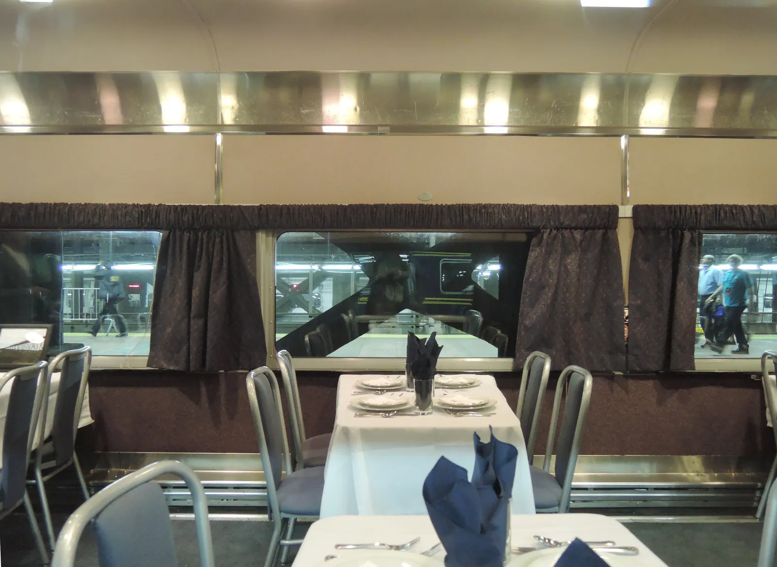 Inside a long dining car with booths