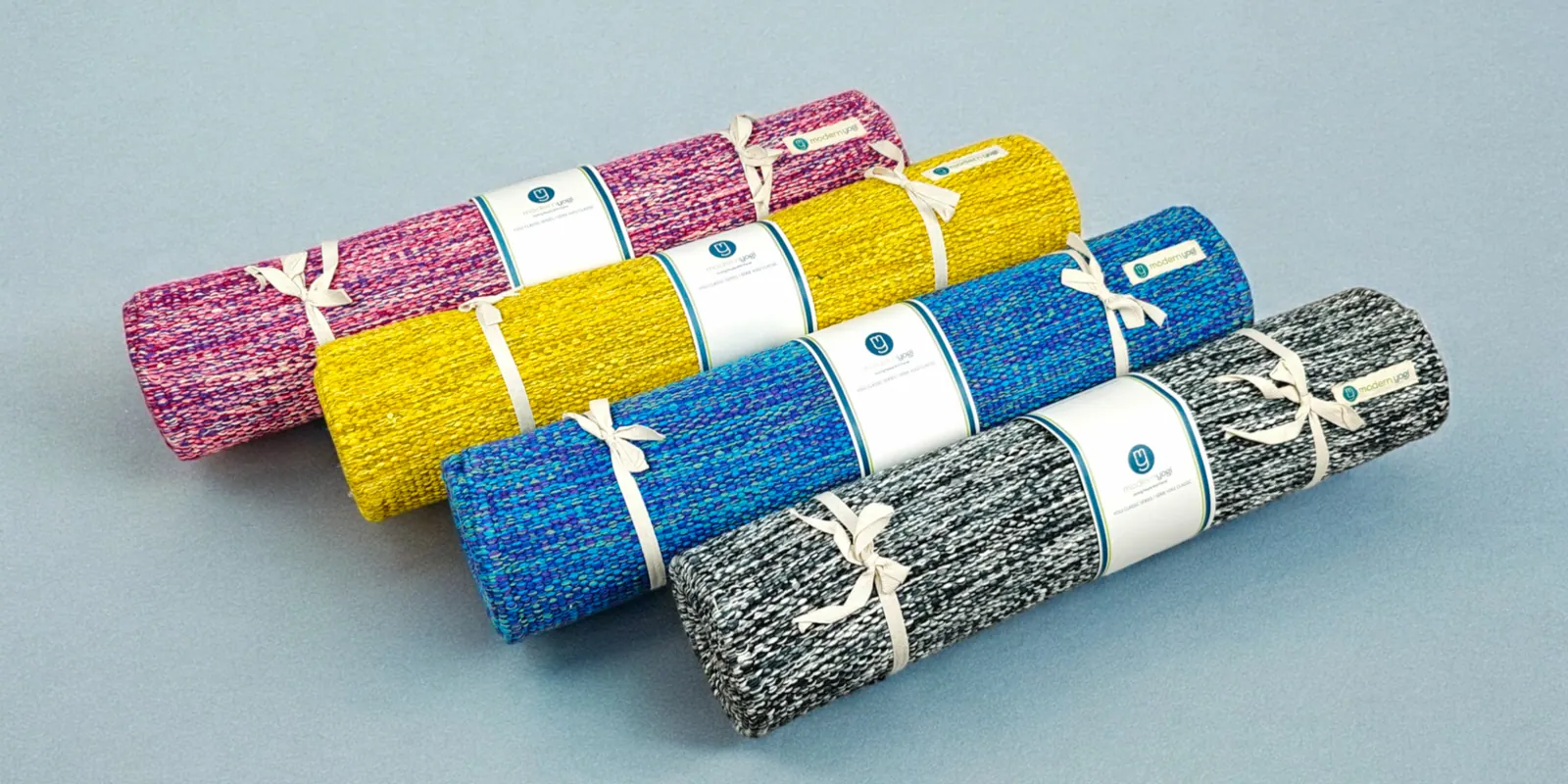 Rolled exercise mats on a studio floor
