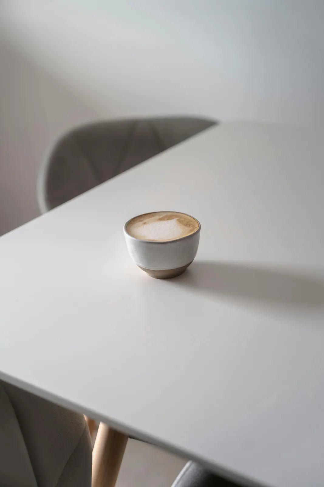 A coffee cup on a tidy modern table